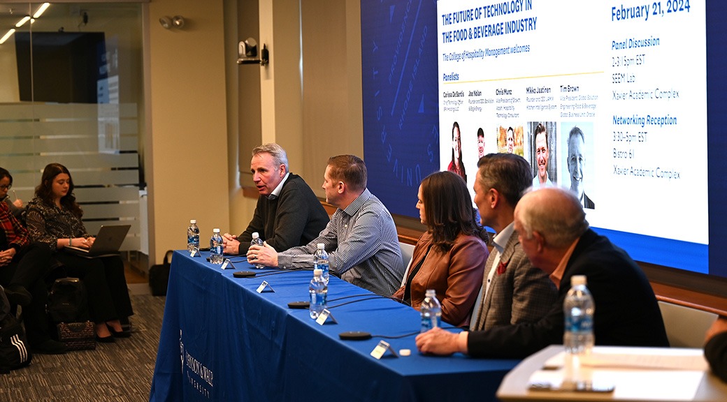 Panelists talking to students about technology