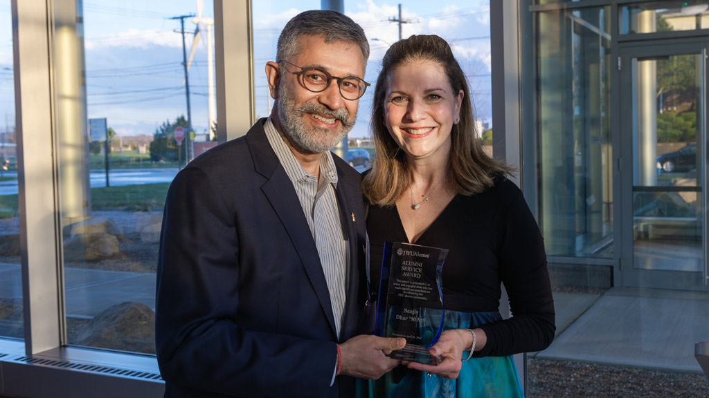 photo of JWU Providence Campus President Marie Bernardo-Sousa, LP.D., ’92, posing with Sanjiv Dhar ’90 M.S.