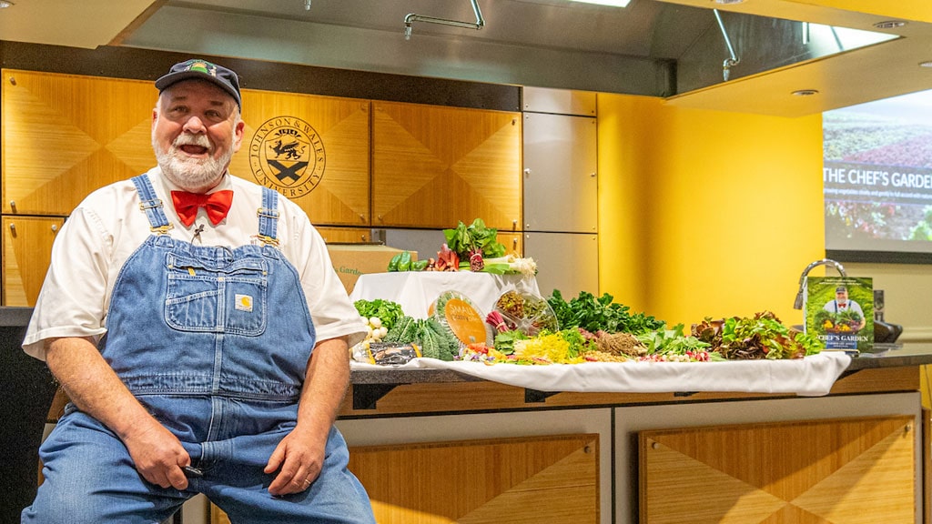 Farmer Lee Jones with a table full of Chef’s Garden produce.