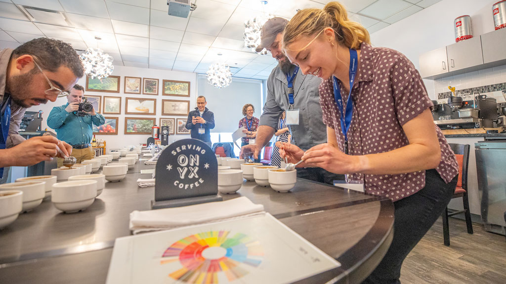 Attendees of Jecinda Wilson’s coffee cupping workshop taste rare coffee varietals.