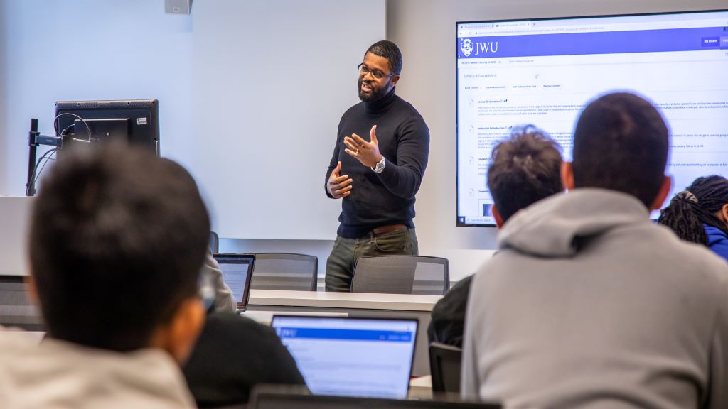 Associate Professor Douglas Tondreau discussing cyber threat with students in the College of Engineering and Design.