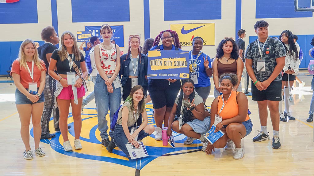 New students in the Queen City Squad pose with their orientation leader.