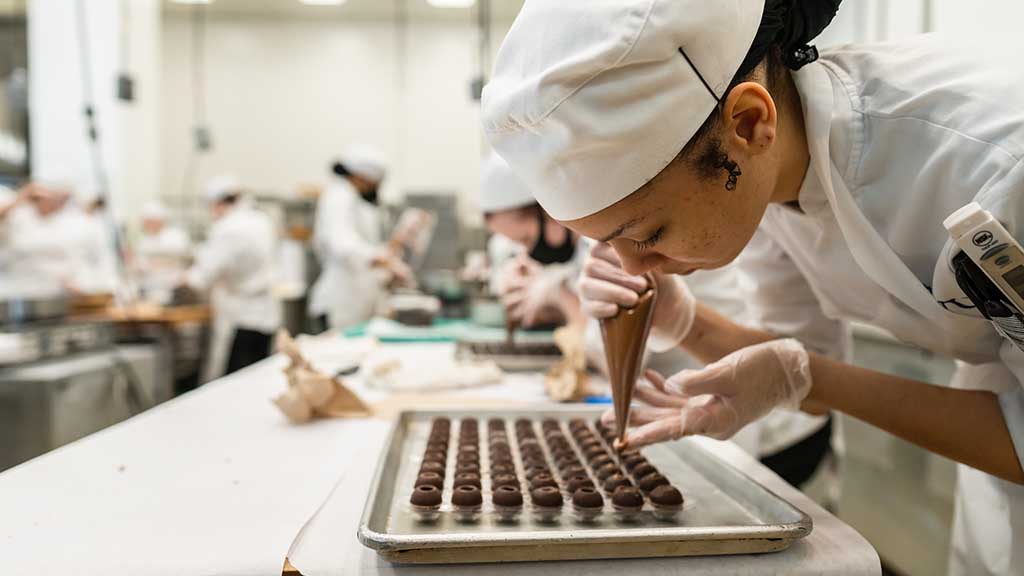 Baking &amp; Pastry student in the Chocolate Lab on the Charlotte Campus.