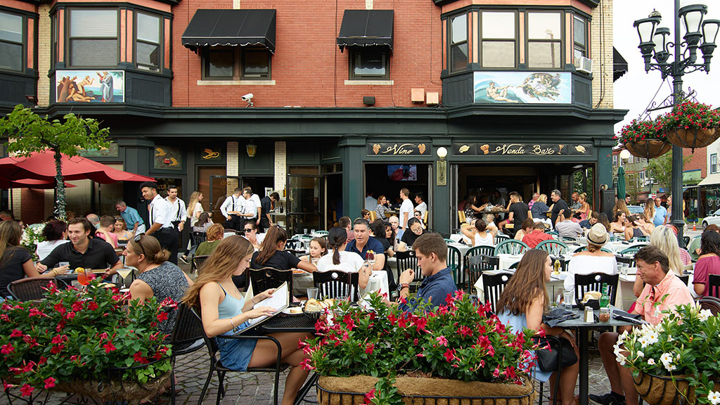 People eating outside in DePasquale Square in Federal Hill neighborhood