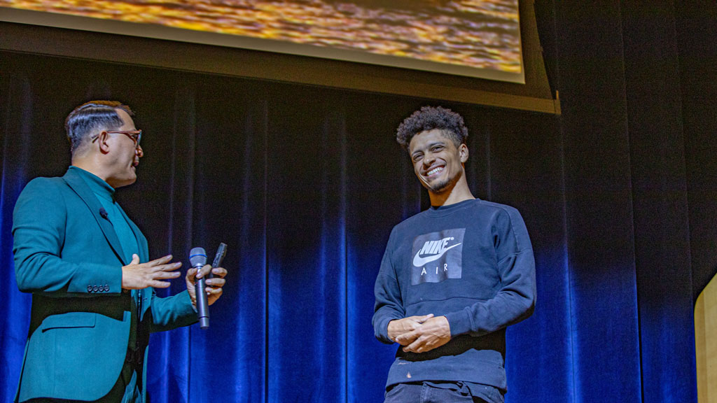 a photo of Eduardo Duran, left, and a JWU student, right, on stage