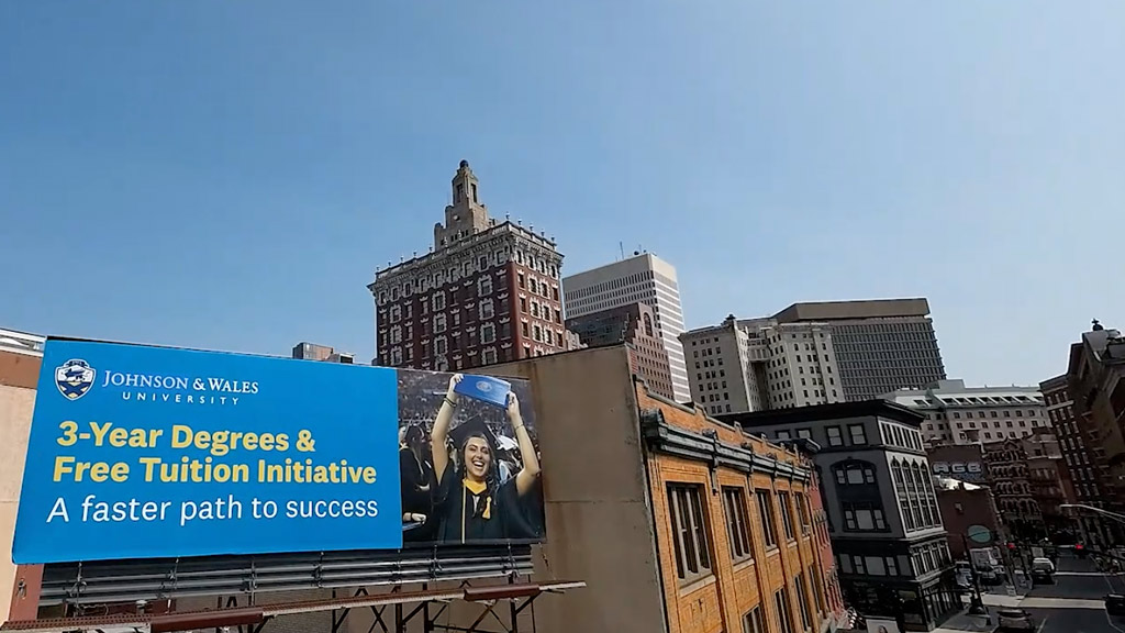 an aerial photo of a JWU billboard near the Providence Campus