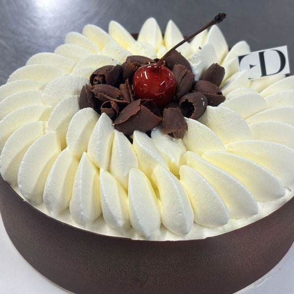 Chocolate cake with a cherry on top by Zoé Rodgers. 