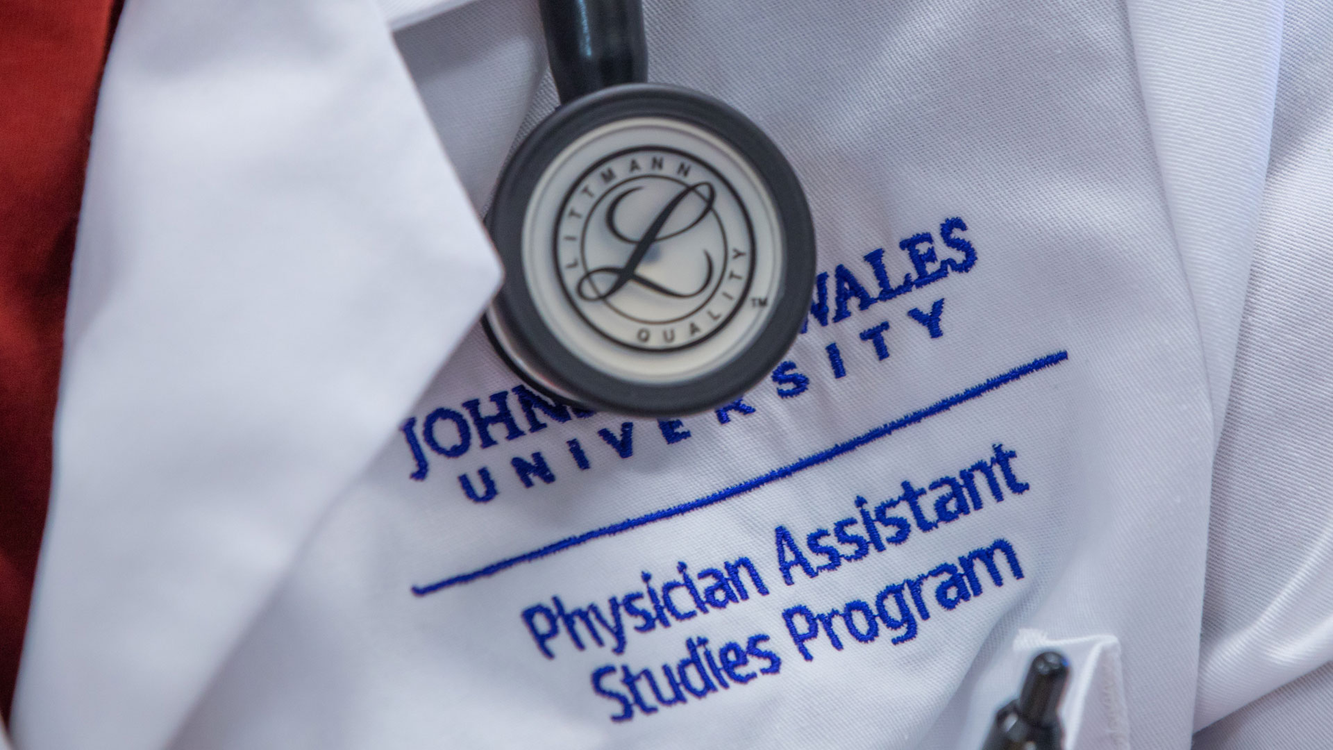 closeup of JWU Center for Physician Assistant Studies embroidered on lab coat