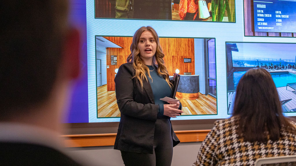 Hospitality Management student presenting her project to students and faculty.
