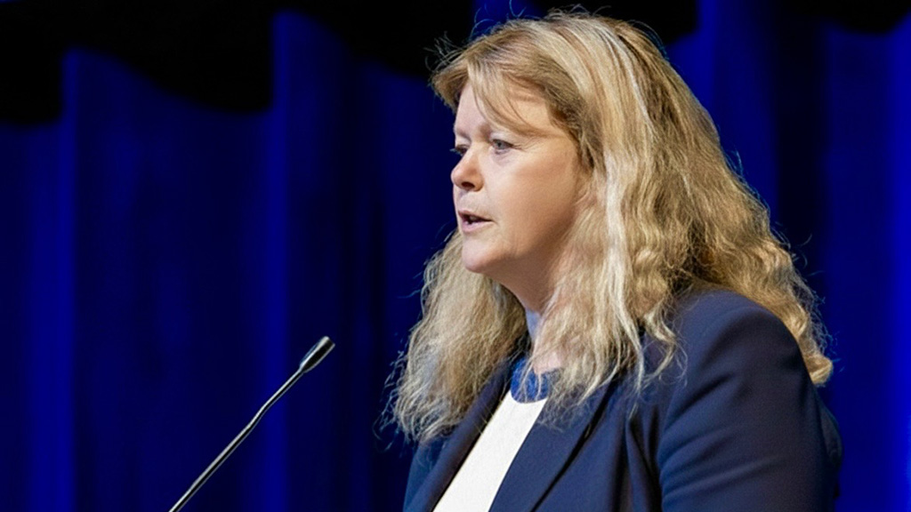 Dean Maura Daley Iversen speaks at a podium at the ABSN pinning