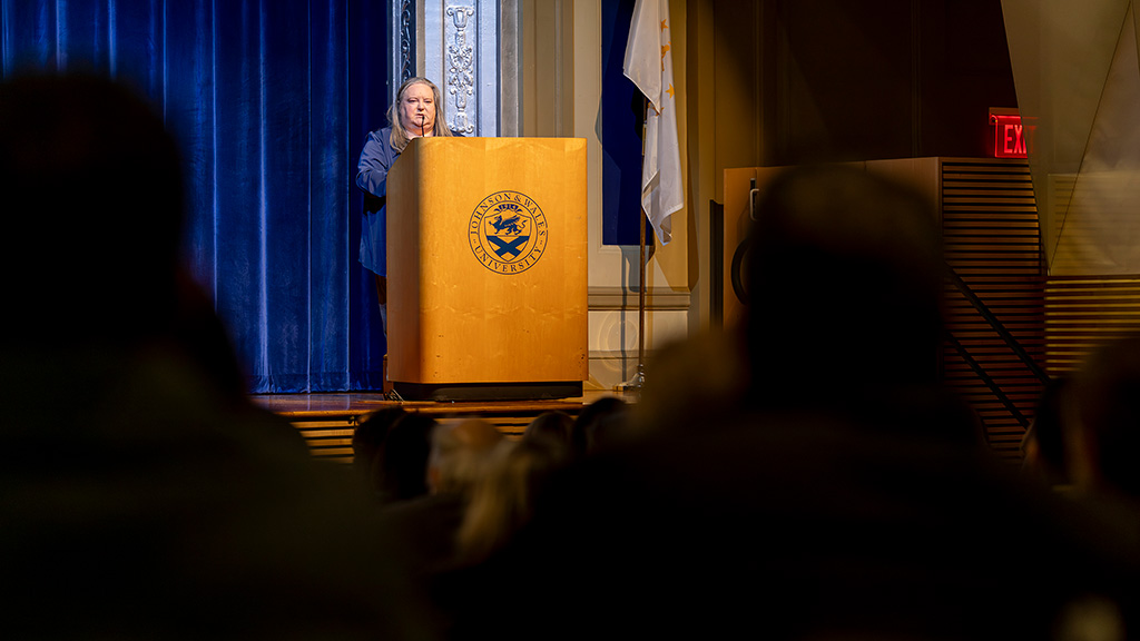 ABSN program director Kiley Medeiros speaks at a podium