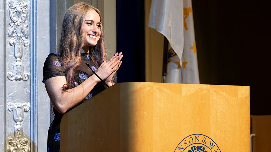 ABSN Class of 2025 student speaker Joelle Medici smiling on stage