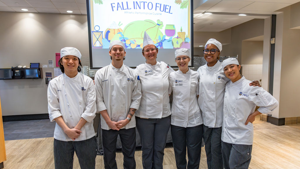 Associate Professor Genny Komar, center, poses with her Athletic Performance Cuisine students.