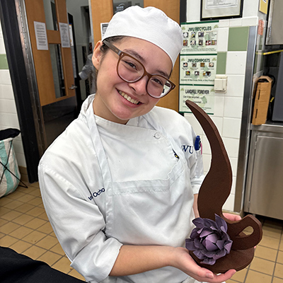 Isabella Ochoa '26 proudly holds up a culinary creation