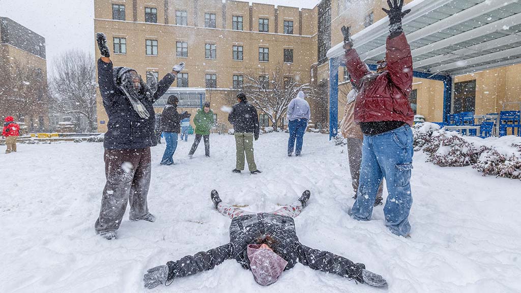 Group of students playing in the snow.