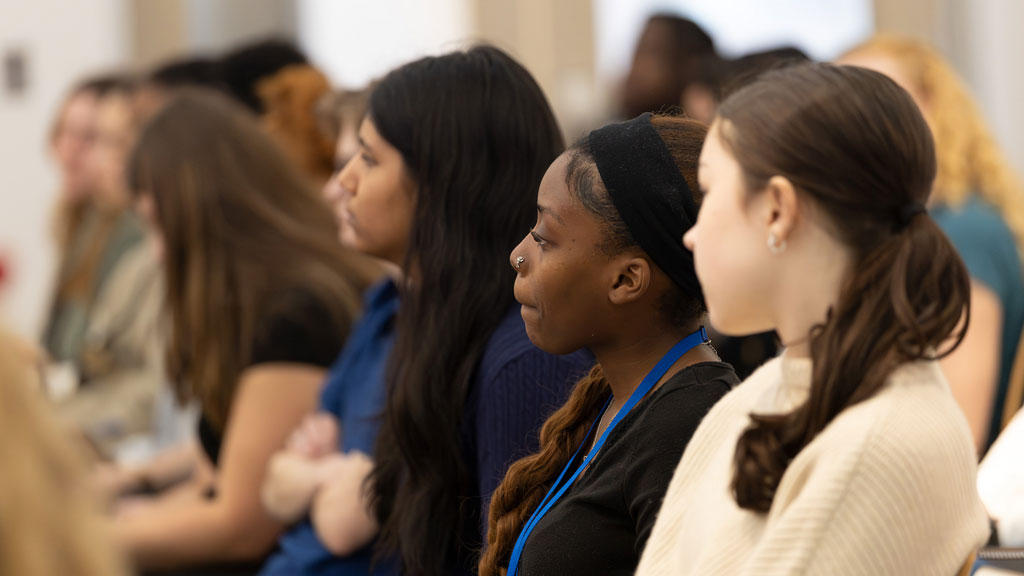 Audience of students listening to speakers.