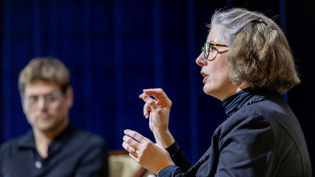 C. Morgan Grefe raises her hands to emphasize a point onstage at JWU. 