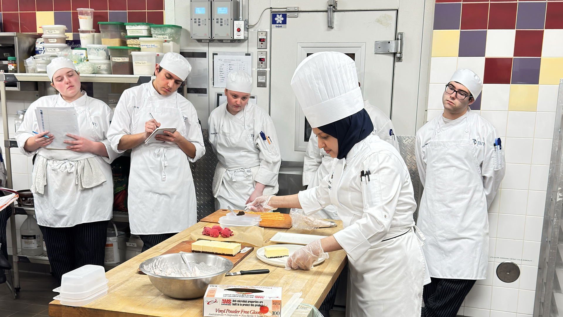 M.A.T. Student Teacher Nimra Farooqui leading a kitchen lesson for undergraduates.