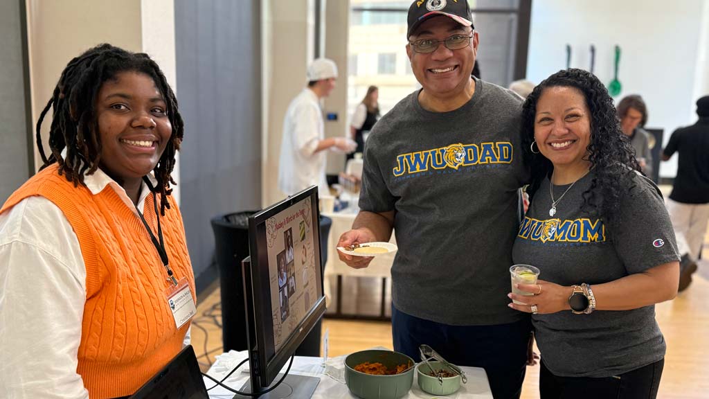 A student presenting their project to their parents 