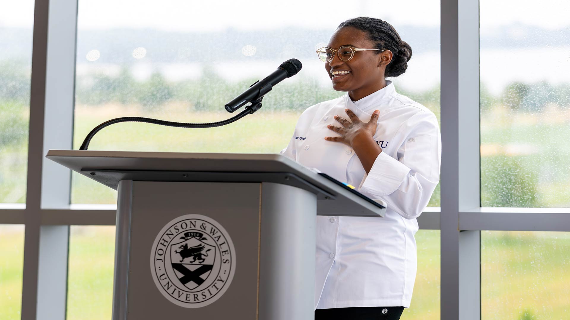 Johanna Evans speaking at podium at the event.