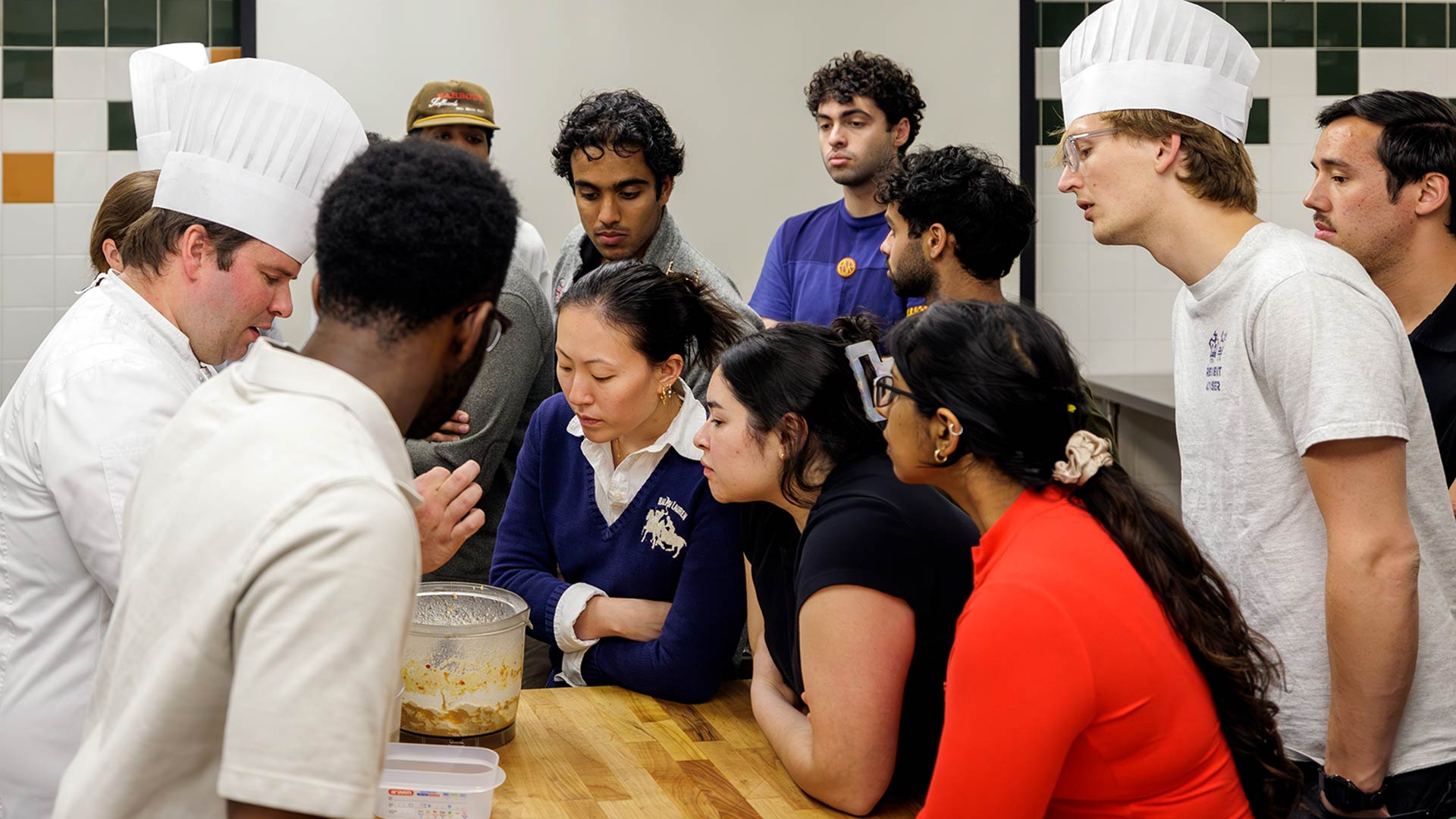 action shot of Brown medical students learning in a JWU culinary lab